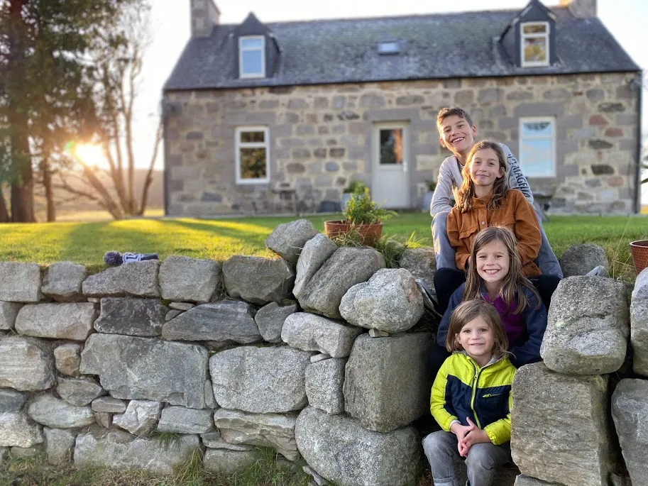 Kids on Stairsteps by Scottish cottage