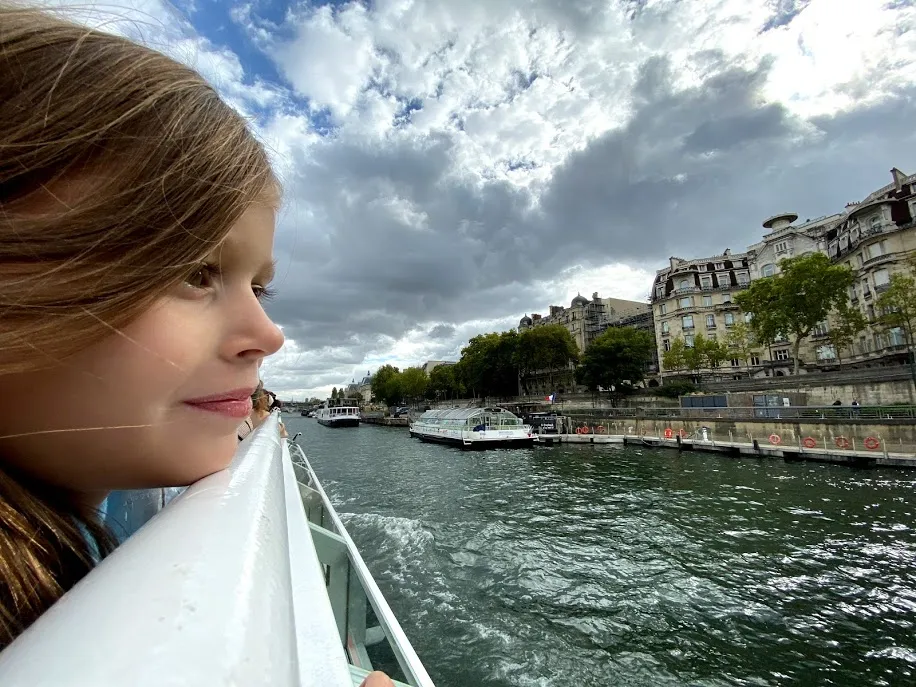 Girl overlooking Seine River on cruise