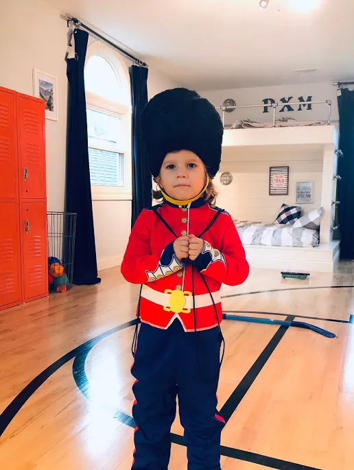 Toddler in British Guard Costume in boy's basketball bedroom